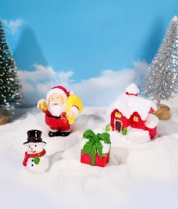 Miniature Christmas resin figurine set featuring Santa Claus, snowman, and snowy house