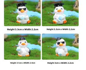 Macro detail of four mini resin graduation ducks with size specs on green grass background