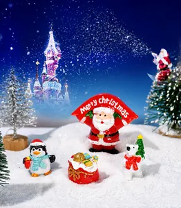 Miniature resin set with Santa Claus, penguin, polar bear and gifts in a snowy scene