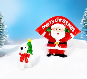 Close-up of Santa Claus with banner and polar bear resin miniatures in snow scene
