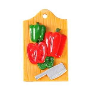 3D resin refrigerator magnet featuring a realistic yellow cutting board with peppers and knife