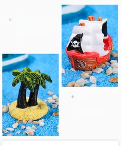 Detailed close-up of resin pirate ship model and coconut tree for micro landscape decor