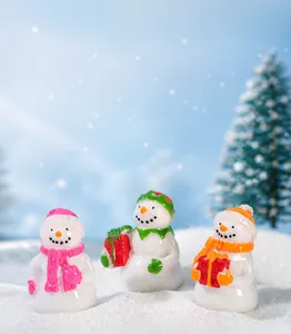 Detailed view of colorful resin Christmas snowmen holding gift boxes and money bags