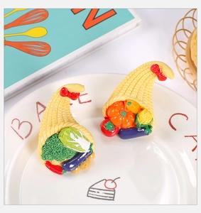 Detail of resin vegetable cornucopia miniatures with bows on a ceramic plate decor