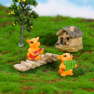 Resin miniature hamster figurines playing guitar and panpipe on a stone path
