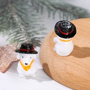 Miniature resin white puppies with black hats and yellow scarves on a wooden stand