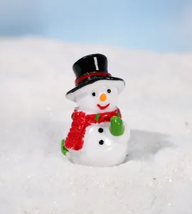 Macro view of a miniature Christmas snowman figurine with red scarf and black top hat