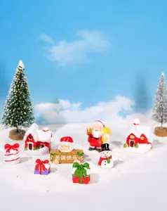 Detailed set of Christmas resin figurines featuring Santa, snowman, and colorful gift boxes