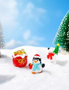 Miniature resin Christmas figurines featuring a gift bag, penguin, and polar bear in snow