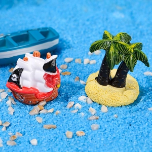 Miniature resin pirate ship with skull sails and palm tree island on blue sand
