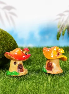 Close-up of resin mushroom houses with textured doors and green moss for terrariums
