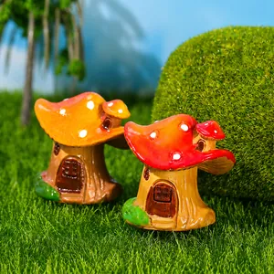 Close-up of red and orange resin mushroom house miniatures for succulent fairy gardens