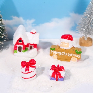 Christmas miniature resin set featuring Santa, snow house, and gift boxes on artificial snow