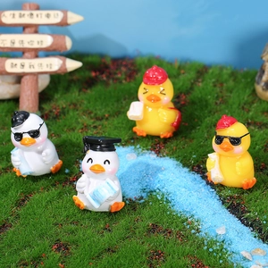 Set of four cute duck figurines in miniature landscape for desktop and plant decor