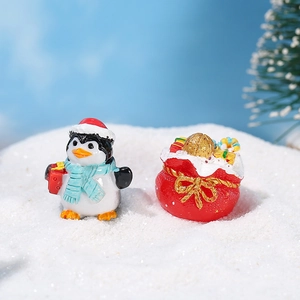 Christmas miniature resin set featuring a penguin with gift box and a red festive bag