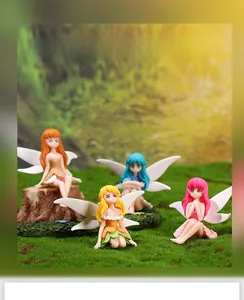 Detail of four fairy figurines with translucent wings on mossy micro landscape