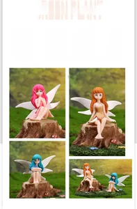 Detailed view of resin flower fairy figurines with white wings on wooden stumps