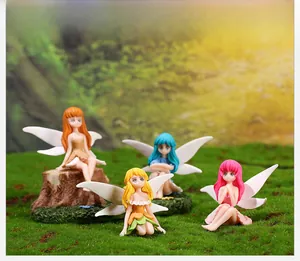Detail view of four colorful miniature flower fairy resin figurines with white wings