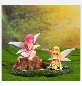 Macro shot of two resin flower fairies on a stump base for moss micro landscapes