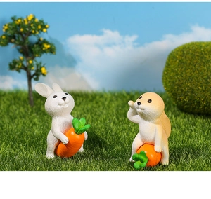 Miniature rabbit and hamster resin figurines on artificial grass for garden micro landscape