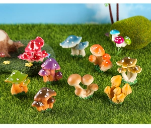 Detailed view of colorful resin mushroom miniatures on moss for garden landscaping