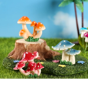 Three colorful resin mushroom figurines with white dots on moss for fairy gardens
