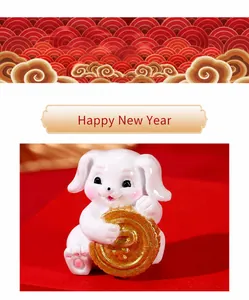 Miniature resin white rabbit holding a golden coin for New Year home decor