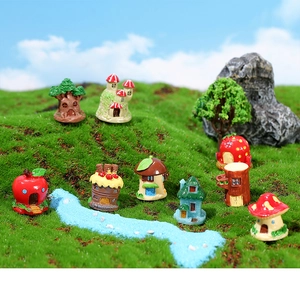 Macro detail of various fairy-style resin miniature houses on a decorative lawn