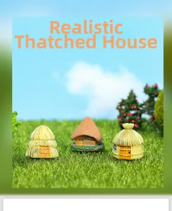 Detailed view of three miniature resin straw huts on artificial moss for terrarium decor