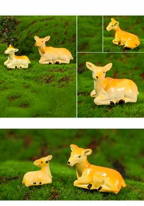 Close-up of a mother and baby deer resin figurine set on a green artificial lawn