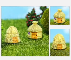 Macro detail of resin miniature thatched cottages for moss micro landscapes