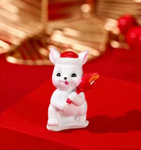 Close-up of a cute white resin rabbit figurine wearing a red hat for festive decoration