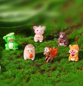 Primer plano de las figuras de animales de resina sobre musgo verde decorativo