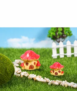 Macro view of miniature resin mushroom houses with red tops and window details for terrariums