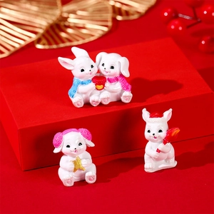 Miniature resin rabbit figurines set with festive gold and red holiday decorations
