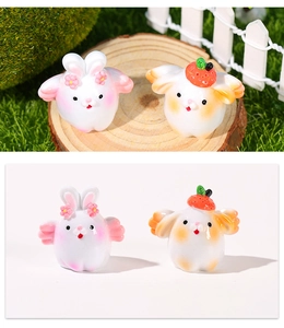 Macro detail of miniature resin flying rabbits with floral and strawberry hats for bonsai