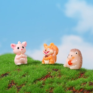 Cute miniature resin animal figurines featuring hedgehog and squirrel on green moss