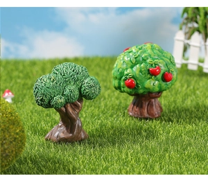 Close-up of miniature resin fruit trees and lush green bushes for fairy garden decor