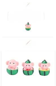 Detailed view of three resin miniature elephants wearing watermelon hats for desk decor