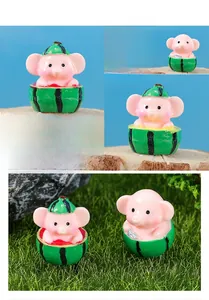 Detailed macro view of pink resin elephant miniature wearing a watermelon textured hat