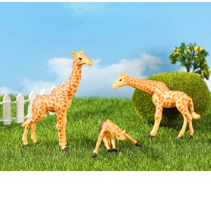 Detailed view of realistic giraffe figurines with skin texture in garden scenery