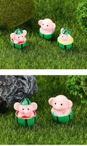 Detail of pink pig resin figurine inside watermelon base for garden micro landscape
