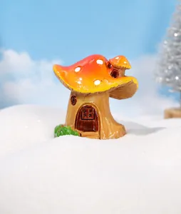 Miniature resin mushroom house decor with red spotted roof and green moss details