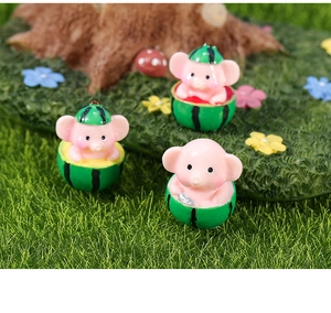 Macro view of cute resin pig and watermelon figurines for garden landscape decor