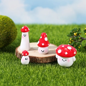 Set of four cute red resin mushroom figurines with smiling faces for garden decor