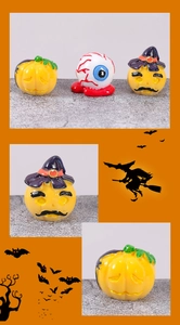 Macro view of Halloween resin ornaments featuring spooky eyeballs and wizard hat pumpkins