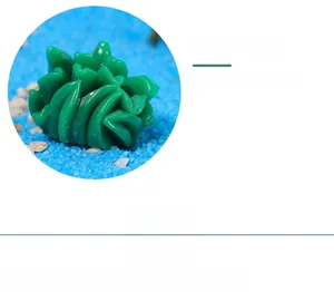 Close-up of green resin coral ornament on blue decorative sand for aquarium aquascaping
