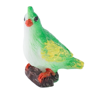 Colorful miniature parrot figurine in green and yellow on a wooden base for garden decor