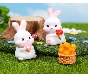 Miniature resin garden decor featuring cute bunnies with hearts and a carrot basket