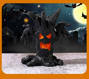 Macro detail of Halloween tree monster ornament with glowing orange eyes and mouth